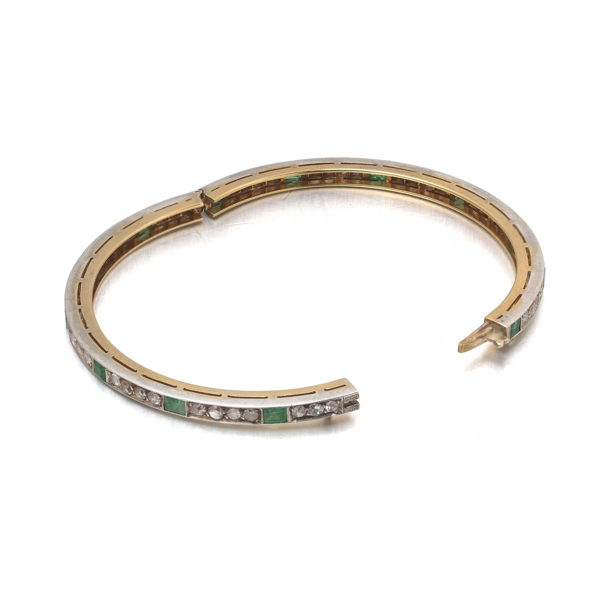 A square emerald and round diamond set bangle bracelet in yellow gold and silver