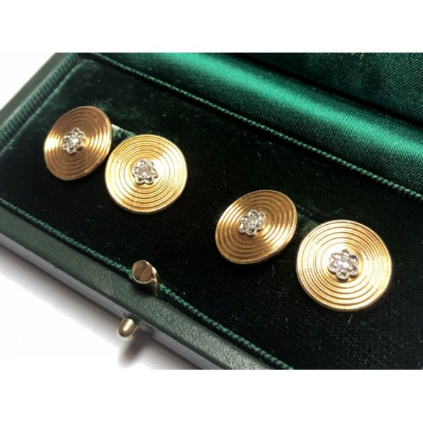 Vintage 1950s Gold and Diamond Cufflinks; circular 18ct yellow gold target cufflinks with concentric circle engraving set with eight-cut diamonds in floral illusion white metal