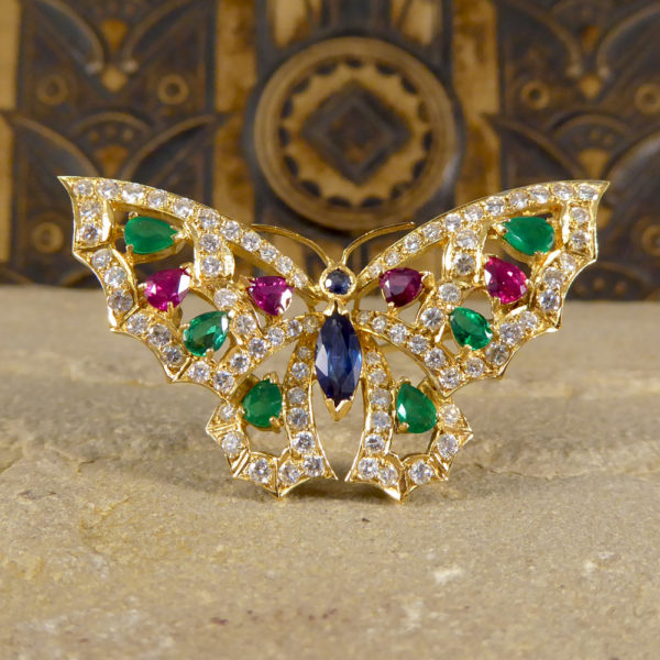 Contemporary diamond emerald ruby and sapphire butterfly brooch in 18ct gold