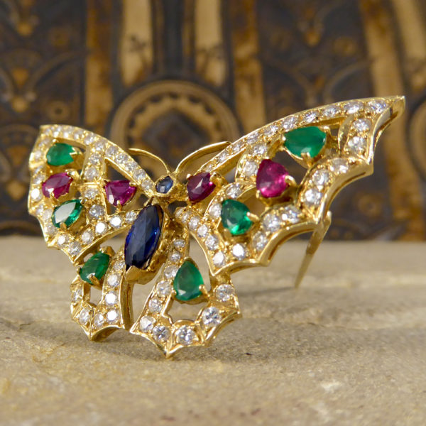 Contemporary diamond emerald ruby and sapphire butterfly brooch in 18ct gold