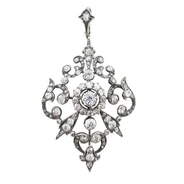 Antique Diamond Pendant/Brooch, open scrollwork and fleur-de-lis design, set in silver and gold