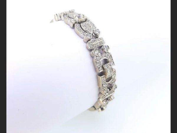 A stunning and intricate vintage diamond set bracelet emulating a hint of the Art Deco style. Diamond total weight is an estimated 12 carats. Bracelet weight: 42g