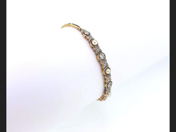 Vintage Pearl and Diamond Bangle; Pearls and round cut diamonds set into an 18ct white gold and platinum bangle. An elegant and luxurious piece.