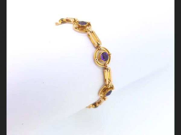 Vintage Amethyst Bracelet: Cabochon amethysts set into a double circular design, interspersed by gate links. A delicate statement piece.