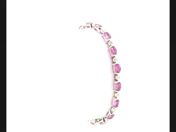 Pink Sapphire & Diamond Bracelet; Oval cut pink sapphires interspersed with round cut diamonds, set in 18ct white gold