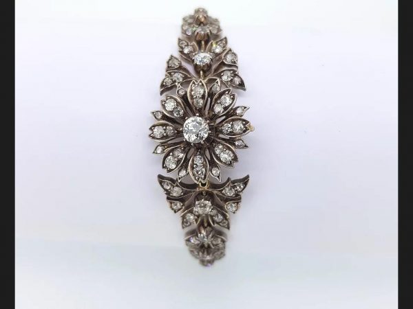 An antique Victorian diamond bracelet set with old cut diamonds in an intricate floral pattern, Set in silver and gold