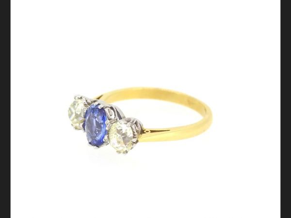 Classic sapphire and diamond three stone ring; Central oval cut Sapphire flanked by two round cut diamonds