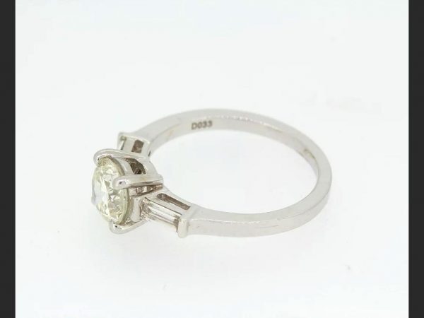 Solitaire Diamond Ring; central 1.23ct round cut diamond, baguette shoulders totaling 0.33ct, set in 18ct white gold