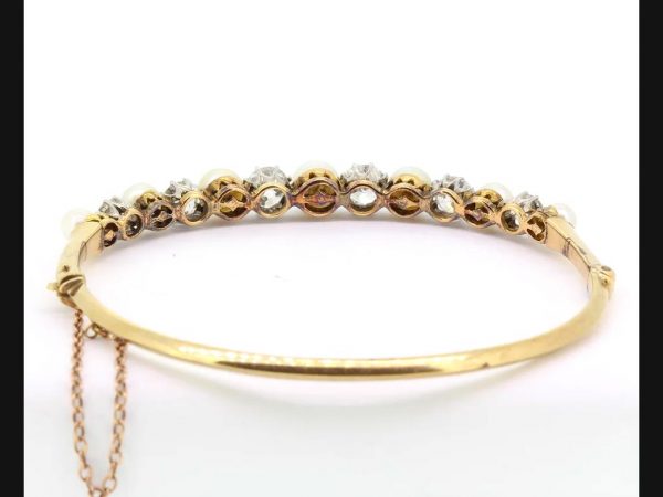 Edwardian natural pearl and diamond bangle, set in 18ct yellow gold and platinum.