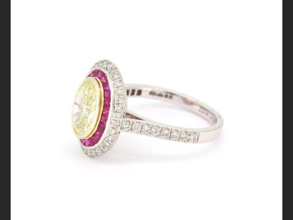 Oval cut Fancy Yellow Diamond and Ruby Calibre Set Ring, certified
