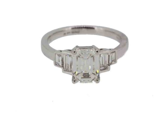 emerald cut diamond engagement ring weighing 1.83 carats flanked by two baguette cut diamonds to each side. Mounted in platinum.
