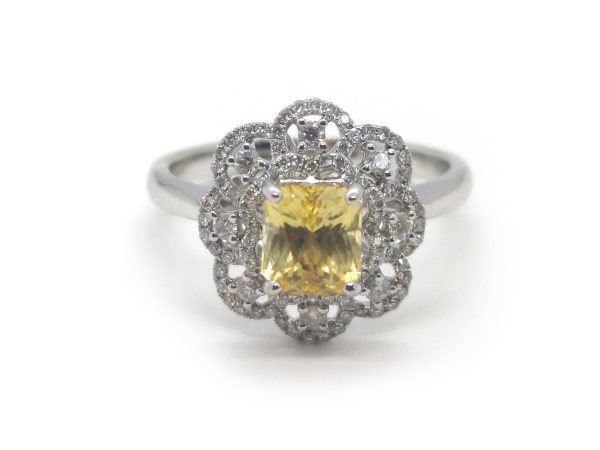natural yellow sapphire no heat 1.50 carats rectangular cut cluster with round brilliant cut diamonds in a floral motif.