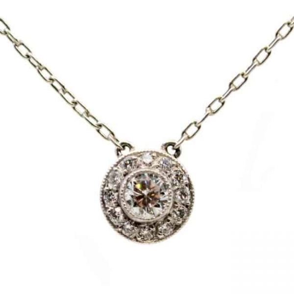 Vintage Art Deco Style Diamond and Platinum Cluster Pendant Necklace; a 0.25ct round brilliant cut diamond surrounded by a halo of diamonds, with chain.