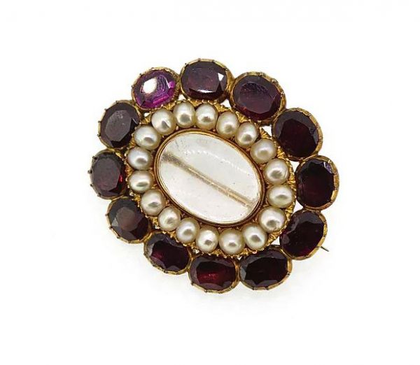 Antique Victorian Garnet and Pearl Memorial Locket Brooch; set with flat-cut oval faceted garnets and split pearls. Mounted in high carat gold. Circa 1860