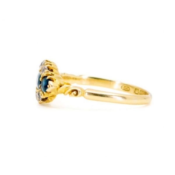 Antique Victorian Sapphire and Old Cut Diamond Ring; three sapphires surrounded by old mine-cut diamonds, 1.18 carat total, set in 18ct yellow gold.