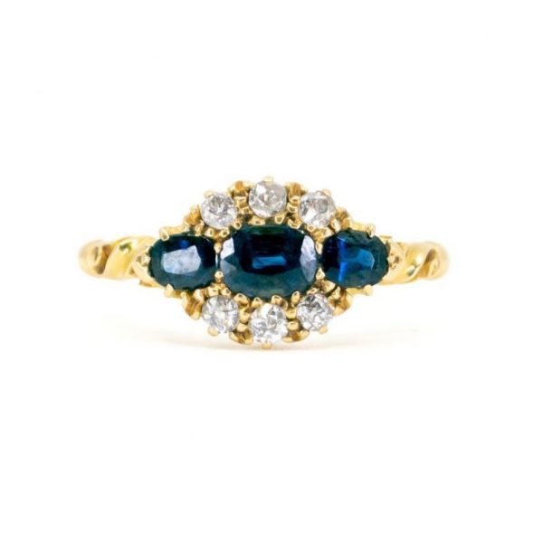 Antique Victorian Sapphire and Old Cut Diamond Ring; three sapphires surrounded by old mine-cut diamonds, 1.18 carat total, set in 18ct yellow gold.
