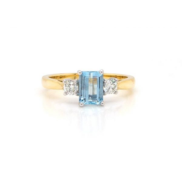Emerald Cut Aquamarine and Diamond Three Stone Ring; 0.91ct emerald-cut aquamarine flanked by brilliant-cut diamonds totalling 0.25cts, 18ct yellow gold.