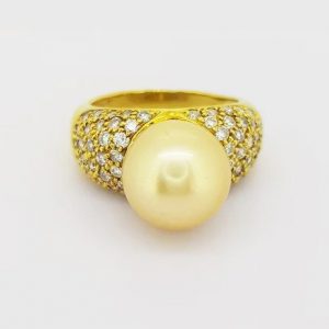 Vintage 11mm Golden South Sea Pearl and Diamond Bombe Dress Ring; A striking golden South Sea pearl and diamond enctrusted ring in 18ct yellow gold.