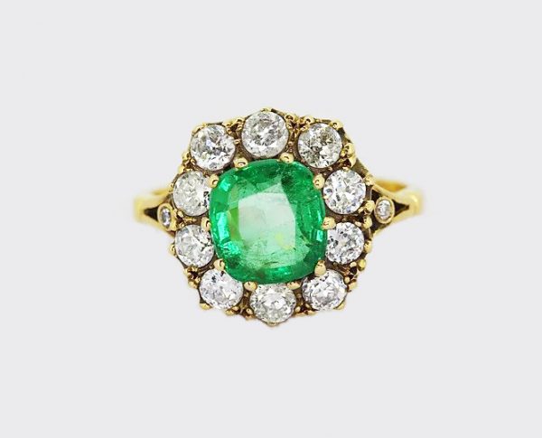 Cushion Cut Emerald and Old Cut Diamond Cluster Ring; central 2.05ct cushion-shaped emerald within a border of 1.10cts old-cut diamonds, 18ct yellow gold.