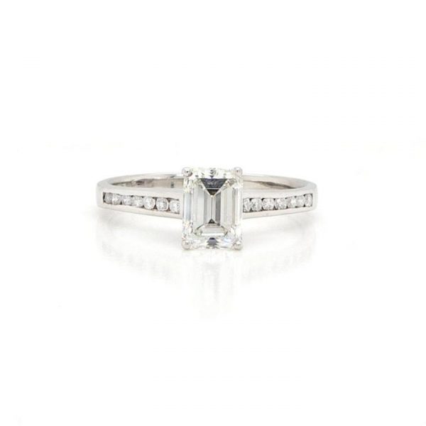 Emerald Cut Diamond Single Stone Engagement Ring; 0.86ct emerald-cut diamond, with channel-set diamond shoulders, F colour, VVS1 clarity, with certificate.