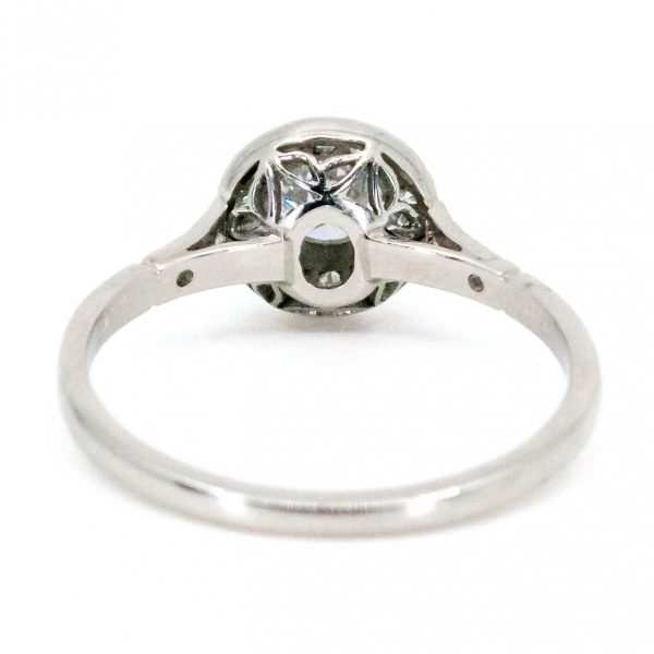 This lovely engagement vintage Art Deco revivalist design ring features a 0.40ct (H SI1) brilliant cut diamond decorated with 0.25ct single cut diamonds crafted in platinum.
