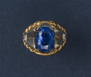 Oval Ceylon Sapphire and Diamond Ring; 11ct oval faceted natural Sri Lanka sapphire, flanked by white gold and diamonds, hammered 22ct yellow gold shank