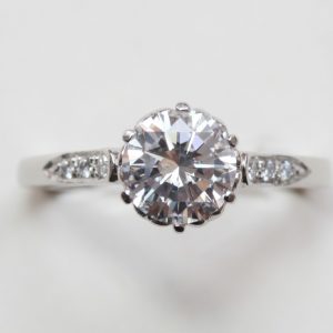Diamond and Platinum Solitaire Engagement Ring; internally flawless 1.28ct round brilliant-cut diamond, colour D, with HRD certificate, flanked by brilliant cut diamonds, heart decorated mount