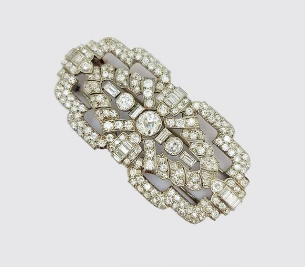 Antique Diamond and Platinum Brooch; A beautiful brooch crafted from platinum, the open-work design set with baguette-cut and circular-cut diamonds.