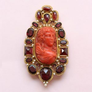Neo Renaissance Style Pearl and Garnet set Cameo Brooch; 19thC cameo surrounded by later small pearls and garnets, 18ct gold, Circa 1980.