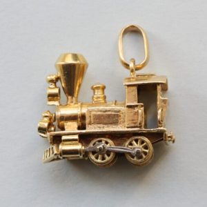 Vintage Van Cleef and Arpels 18ct Gold Locomotive Train Charm; with diamond and emerald set headlights, Signed and numbered, with Van Cleef & Arpels chain.