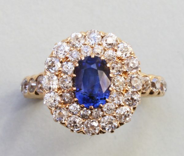 Antique Edwardian Oval sapphire and Old Cut Diamond Cluster Ring; oval faceted 1.5ct natural blue sapphire surrounded by 2.5cts old cut diamonds. Circa 1910