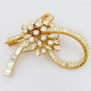 Vintage Multi Cut Diamond Bow Brooch; set with brilliant-cut, marquise-cut and baguette-cut diamonds, 9.00 carat total, mounted in 18ct yellow gold.
