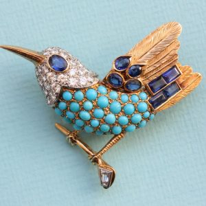 Cartier Vintage Turquoise, Diamond and Sapphire Bird Brooch; set with cabochon-cut turquoises and mixed-cut diamonds and sapphires, Signed and numbered