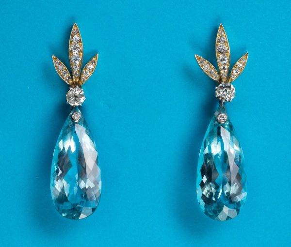 Vintage Aquamarine and Diamond Drop Earrings; diamond set stylized gold leaves suspend a large faceted pear-shaped aquamarine drop