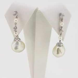 South Sea Pearl and Diamond Drop Earrings; featuring South Sea pearls suspended from a pearl and diamond drop, mounted in 18ct white gold