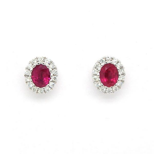 Pair of 1.09ct Ruby and Diamond Oval Cluster Stud Earrings; central oval faceted ruby with a brilliant cut diamond surround, 18ct white gold.