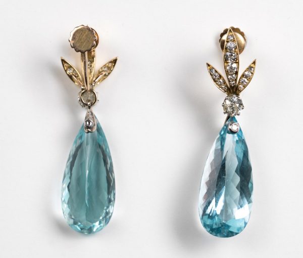 Vintage Aquamarine and Diamond Drop Earrings; diamond set stylized gold leaves suspend a large faceted pear-shaped aquamarine drop