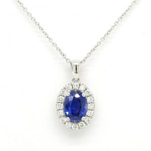 Sapphire and Diamond Oval Cluster Pendant; central 1.08ct oval faceted sapphire surrounded by 0.19cts brilliant cut diamonds, 18ct white gold