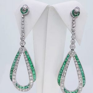 Pair of Contemporary Emerald, Diamond and Platinum Drop Earrings; set with calibre-cut emeralds and round brilliant-cut diamonds, in platinum