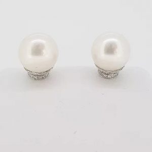 Pearl and Diamond Stud Earrings; featuring cultured pearl studs accented with micro-set diamond collars. Mounted in 18ct white gold.