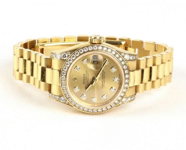 Rolex Oyster Perpetual 26mm Datejust 18ct Yellow Gold and Diamond Ladies Automatic Wrist Watch, Model 179158, factory set diamond bezel and lugs, screw-down Rolex crown, 18ct Rolex President bracelet with a single deployment clasp. With Rolex box and papers, Circa 2006/2007