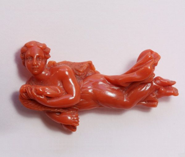 18th Century Carved Coral Angel Brooch; A large carved coral brooch of an angel, Italy, 18th century, 19.1 grams gross weight, 6.1cm long.