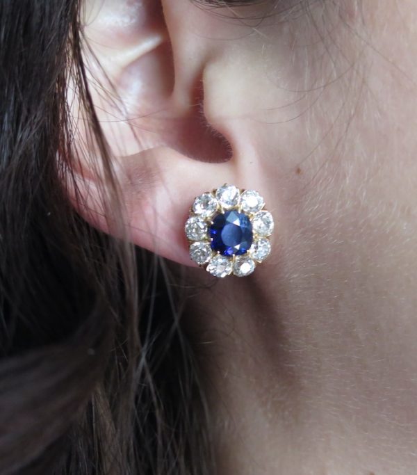 Antique sapphire diamond cluster earrings on the ear
