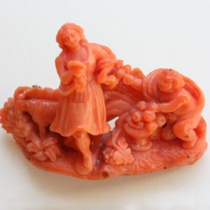 18th Century Carved Coral Brooch; A carved coral brooch featuring a sculpture of a bucolic scene praising country life. Italy, 18th century.