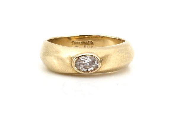 Vintage Tiffany and Co 0.33ct Diamond and 18ct Yellow Gold Ring; set with a 0.33ct oval-cut diamond, Made in Italy, Import London Hallmarks, 2001