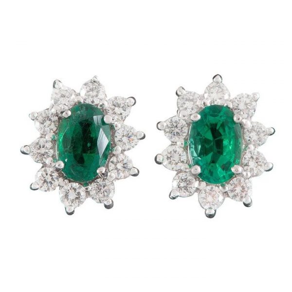 Emerald and Diamond Oval Cluster Stud Earrings; featuring 0.80cts oval faceted emeralds surrounded by 0.56cts brilliant diamonds, 18ct yellow and white gold