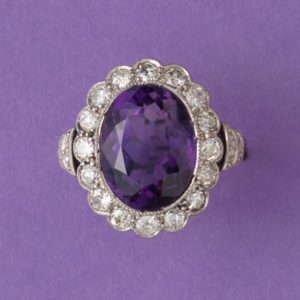 Art Deco Amethyst and Diamond Oval Cluster Ring; large oval faceted amethyst surrounded by 0.50cts old-cut diamonds, pierced white gold mount