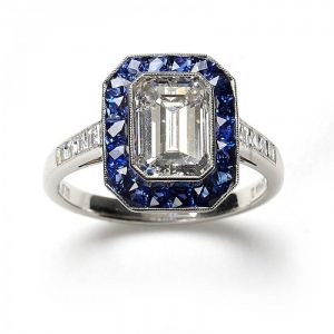 2.01ct Emerald Cut Diamond and Sapphire Cluster Ring; F colour, VS2 clarity, square-cut diamond set shoulders. Set in platinum