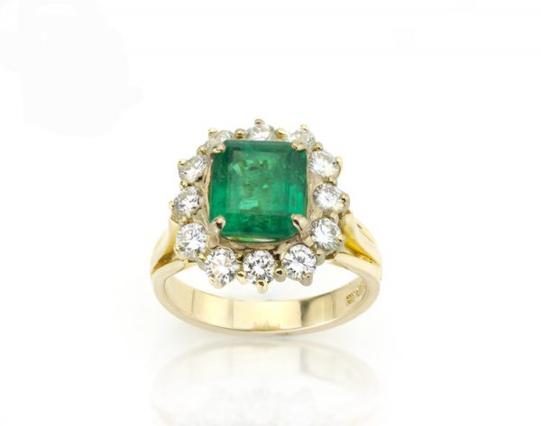 Vintage 3.80ct Natural Colombian Emerald and Diamond Cluster Ring; central 3.80 carat octagonal-cut emerald surrounded by 1.20cts diamonds, 18ct yellow gold, with GCS certificate. Circa 1970's
