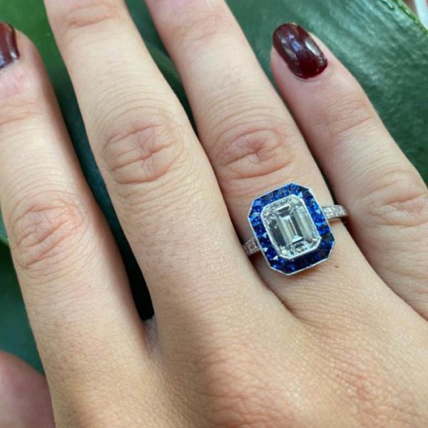 2.01ct Emerald Cut Diamond and Sapphire Cluster Ring; F colour, VS2 clarity, square-cut diamond set shoulders. Mounted in platinum
